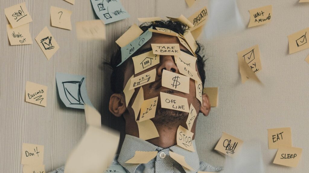 Person overwhelmed by too many tools and notifications